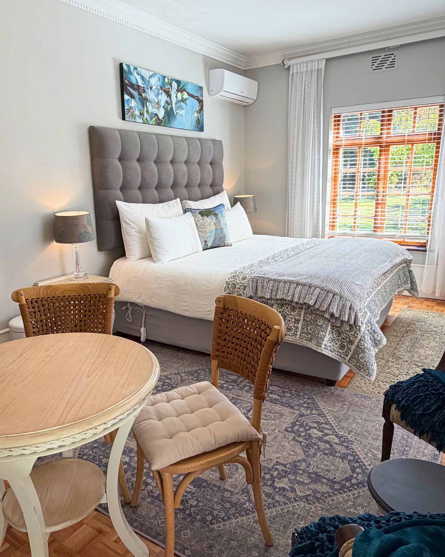 Main room with king-size bed and tufted headboard